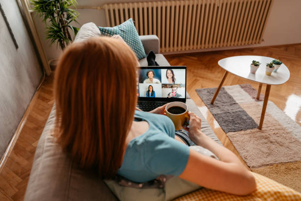 istock Woman drinking coffee with friends on video call 1401380236