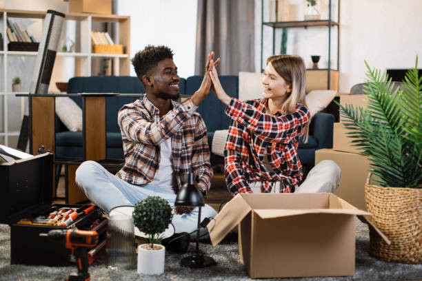 istock Lovely multi ethnic couple giving high five at new home 1401381498