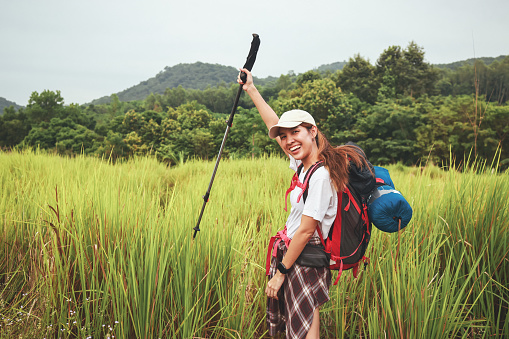 Snap shot Young adventure woman walk trekking on mountain, adventure travel lifestyle, Traveler with Backpack hiking in Mountains