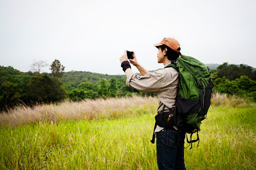 Snap shot Young adventure woman walk trekking on mountain, adventure travel lifestyle, Traveler with Backpack hiking in Mountains