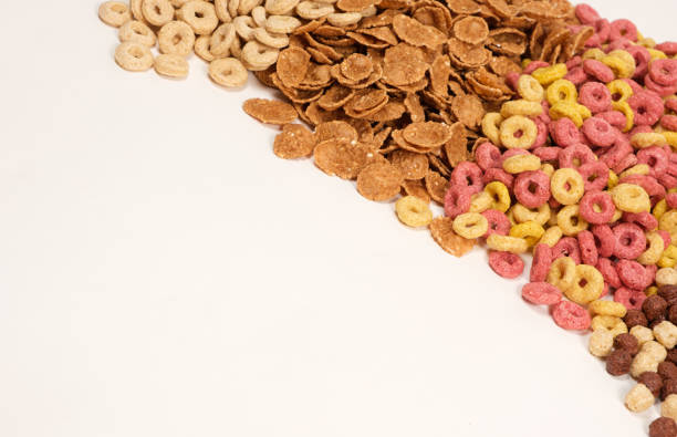 istock Miscellaneous quick breakfast cereals - wheat flakes and corn rings on a white background, space for text 1401381873
