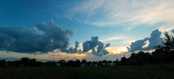 A real sunset sky with beautiful light clouds and sun rays, without birds. Huge permissions