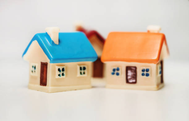 istock Three toy houses on the table. Real estate concept. 1401385834