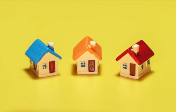 istock Three toy houses on the table. Real estate concept. 1401386406