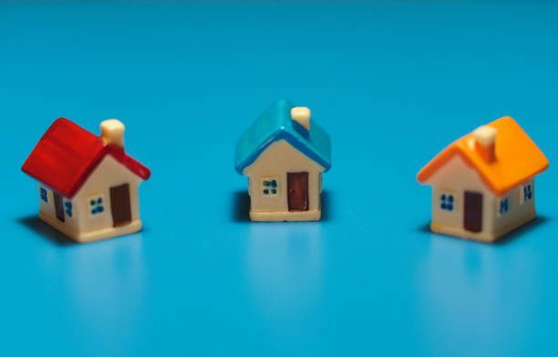 istock Three toy houses on the table. Real estate concept. 1401386409