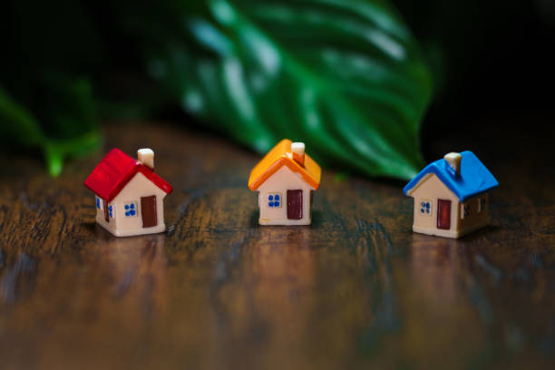istock Three toy houses on the table. Real estate concept. 1401386419
