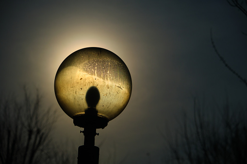 lantern on the street, ancient illumination lamp at day with sun background.