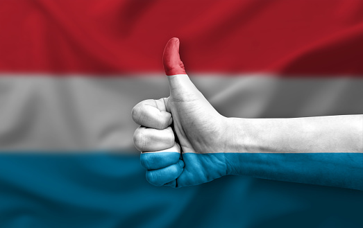 Hand making thumb up painted with flag of luxembourg