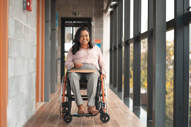 istock Businesswoman in a wheelchair using smartphone 1401389607