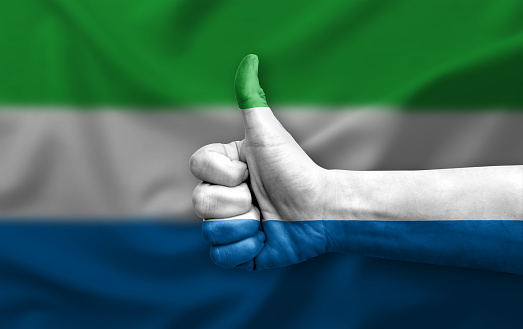 Hand making thumb up painted with flag of sierra leone