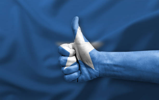 Hand making thumb up painted with flag of somalia