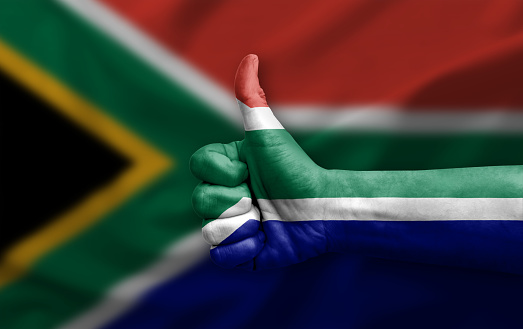Hand making thumb up painted with flag of south africa