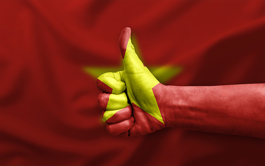 Hand making thumb up painted with flag of vietnam