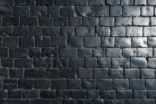 Natural black paving stones texture background