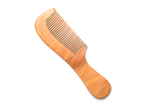 Wooden comb isolated on white background, top view.