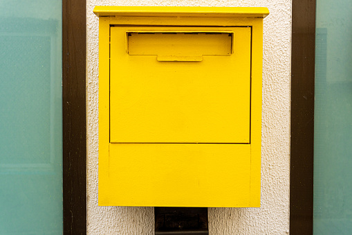 Close-up of yellow postbox