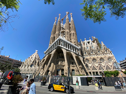 Barcelona, Spain, - May 22, 2022.Tourists on tour andphotographing the Segrada Famila in the city of Barcelona.