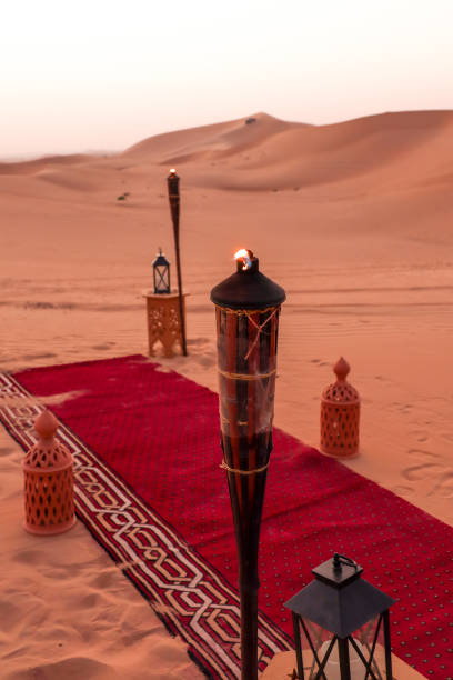 istock Desert dinner set up for sunset romantic meal at sand dunes with carpets and cushions 1401402086
