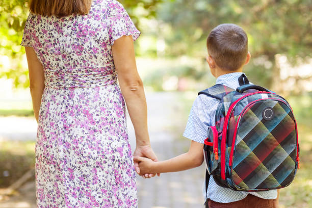 istock Back to school. Schoolboy is ready go to school. Cute child with a backpack outdoors. First day at school 1401402679