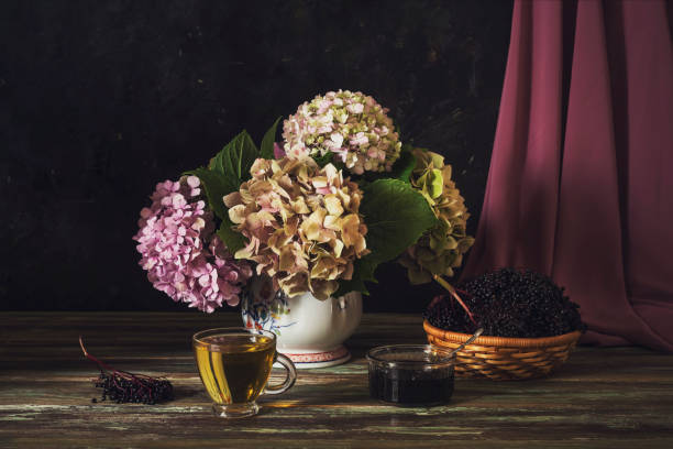 istock Still life with hydrangea, a cup of tea and elderberry jam on a wooden table 1401403372