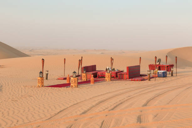 istock Desert dinner set up for sunset romantic meal at sand dunes with carpets and cushions 1401403461