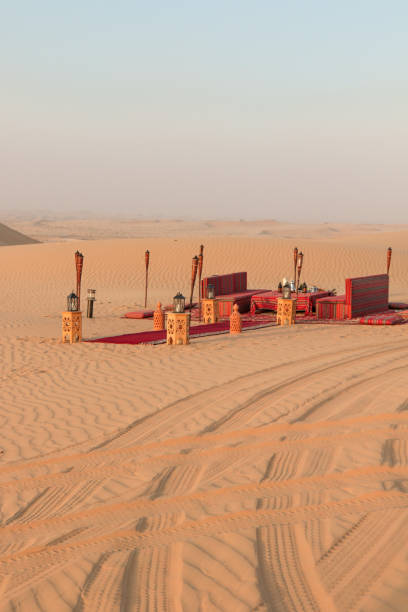 istock Desert dinner set up for sunset romantic meal at sand dunes with carpets and cushions 1401403481