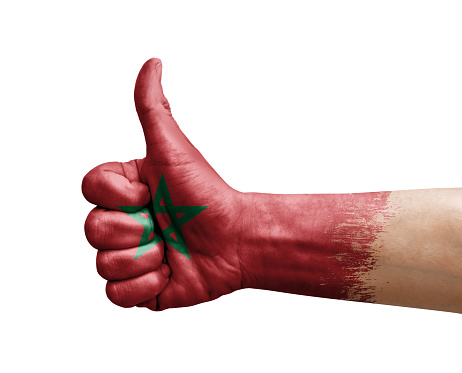 Hand making thumb up painted with flag of morocco