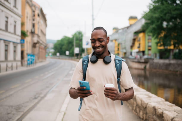 istock Happy young man enjoying his free time outdoors, using a smart phone 1401405192