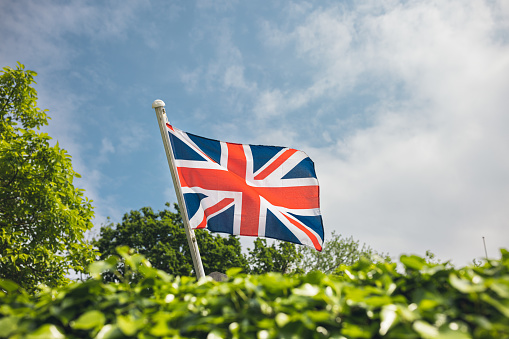 Union Jack flag United KingdomUnion Jack flag and London street in a background during the Platinum Jubilee celebration