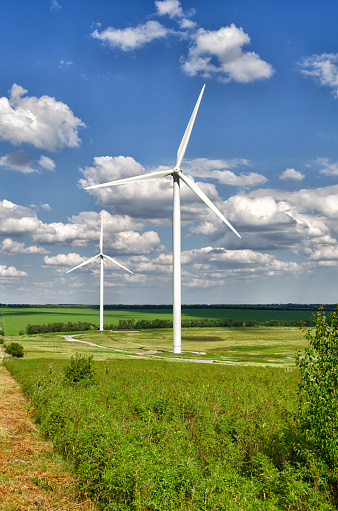 Wind energy, alternative energy. Windmills stand in the field and produce electricity