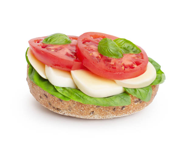 istock whole grain bread sandwich with mozzarella, tomatoes and basil on a white isolated background 1401406889