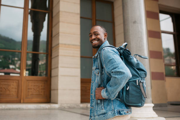 istock Young adult university student entering the educational building 1401407457