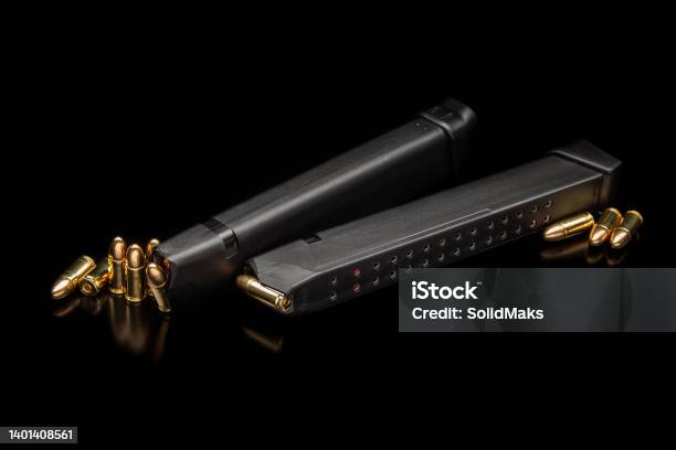 Pistol Cartridges 9 Mm On A Smooth Glossy Surface With Reflections Ammunition For Pistols And Pcc Carbines On A Dark Background Stock Photo - Download Image Now