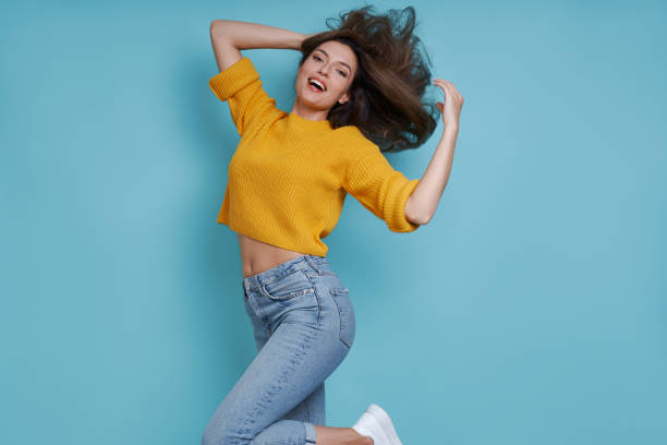istock Beautiful young woman having fun against blue background 1401410996
