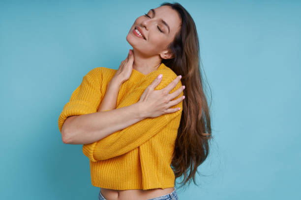 istock Attractive young woman hugging self and smiling 1401411324