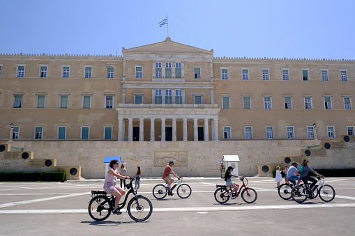 People walks in front of the Greek Parliament during a hot day in central Athens, Greece on May 25, 2022.