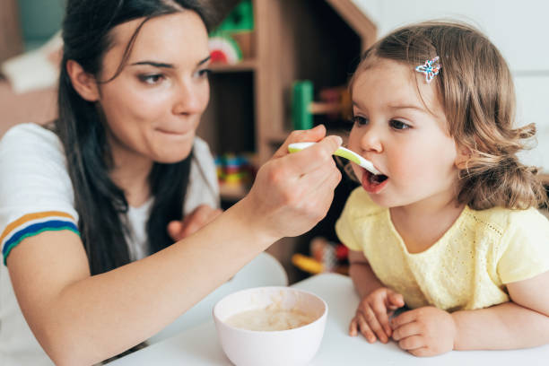 istock Mother feeding her girl 1401416461