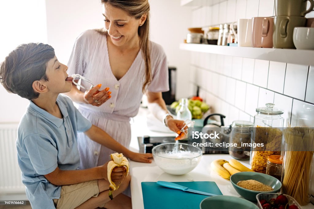 It's tastes so good Mother and son make whipped cream in the kitchen 35-39 Years Stock Photo
