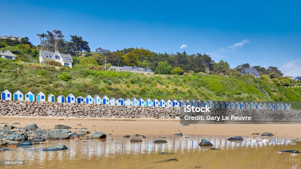 Beach huts at Plage de Carteret, France Plage de Cartret beach with seaside huts on a sunny day. in France Barneville-Carteret Stock Photo