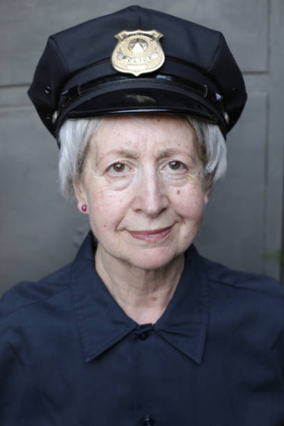 Senior female officer in uniform A senior female police office in uniform is looking at camera.She has gray hair with short length. police policewoman women spain stock pictures, royalty-free photos & images