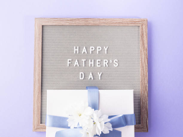 istock Fathers day purple greeting card with text on letter board 1401421270