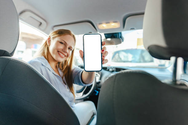 Woman in the car, holding smartphone. Chroma Key. stock photo