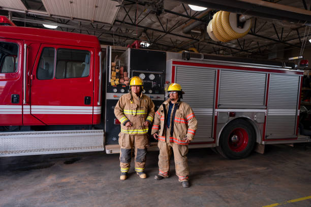 istock Two Confident Men Standing Nest To A Fire Engine With Their Gear On,  Prepared For Assisting Any Kind Of  Emergency That Should Arise 1401421758