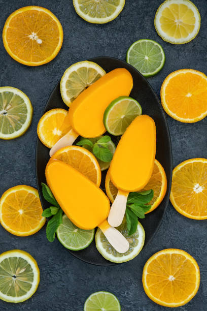 Yellow ice cream with citrus fruits, top view