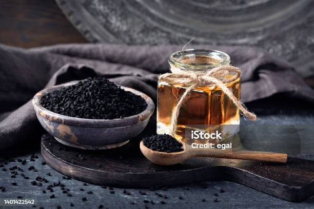 Black Seeds In A Bowl And Oil Stock Photo - Download Image Now - Nigella, Cooking Oil, Black Color