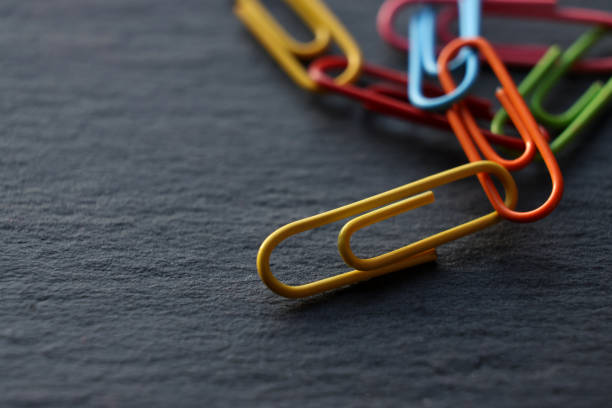 istock Paper clip on black background 1401422757