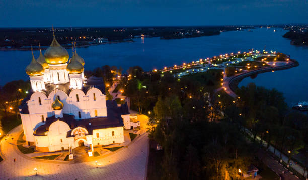 Scenic view from drone of medieval Yaroslavl Orthodox Assumption cathedral on background with Volga River and cityscape at night, Russia