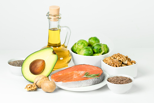 foods high in fatty acids, omega 3 and omega 6 on a light background