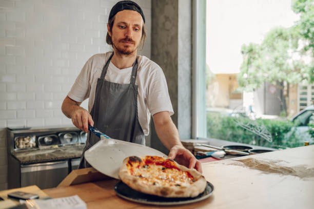 istock Portrait of a kitchen chef working in a pizza place 1401428062