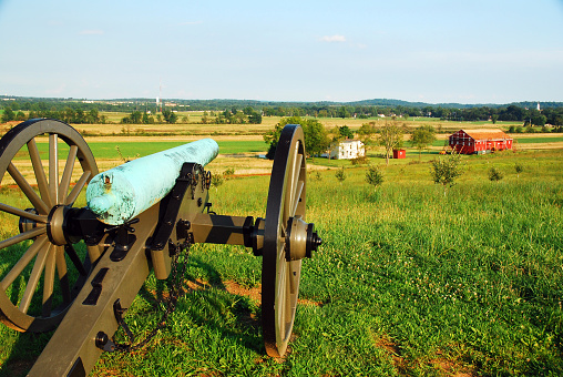A cannon, a relic from the American Civil War, seems to take aim at a farmhouse near the Gettysburg National Military Park in Pennsylvania